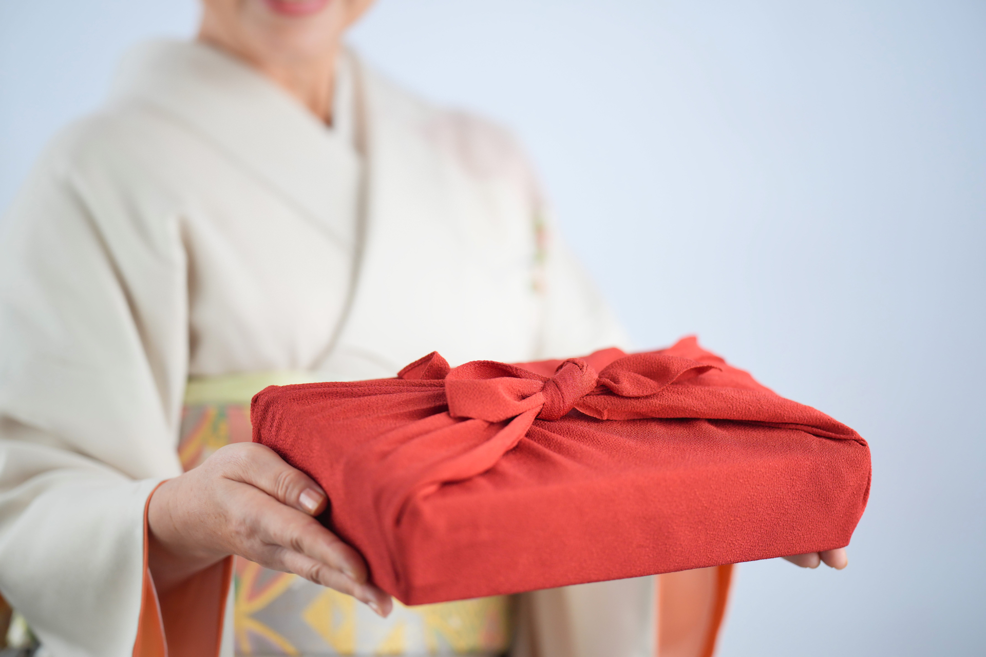 A gift wrapped in red furoshiki cloth.