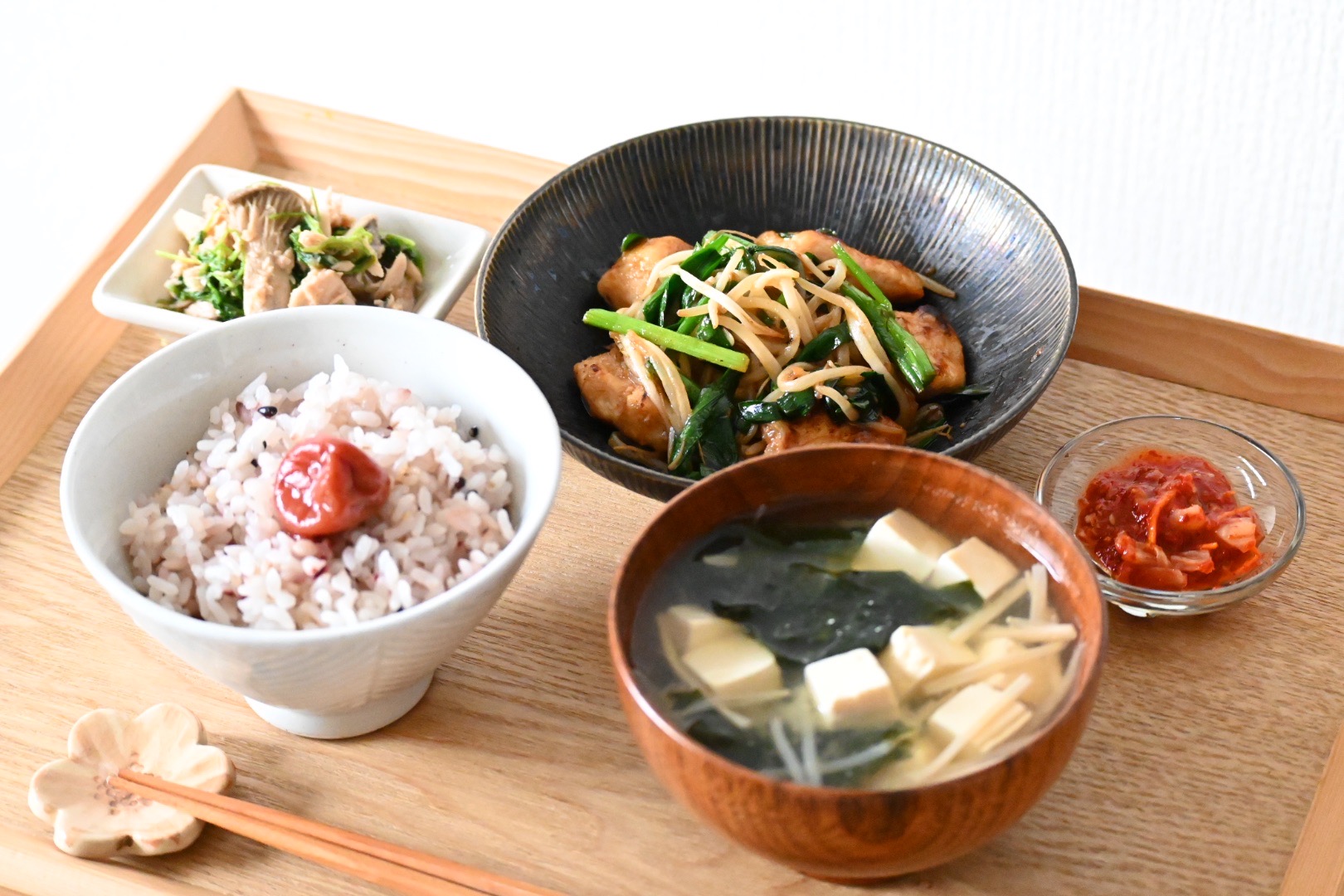A Japanese meal on a tray with rice, soup and several side dishes.