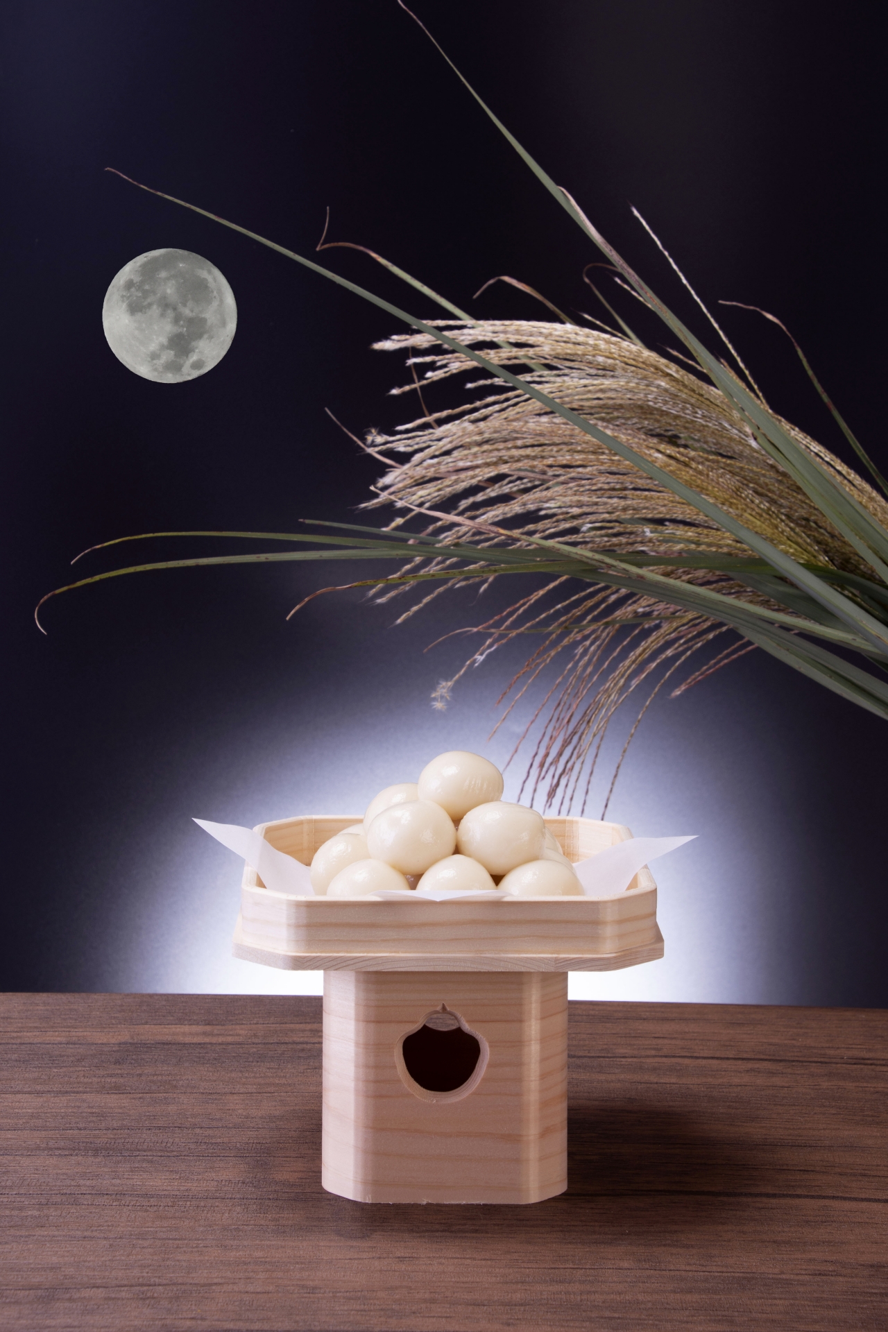 Full moon above susuki grass and an offering of dango.