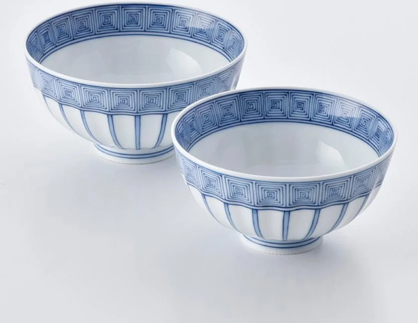Two white Mikawachi porcelain rice bowls with fine cobalt-blue geometric decoration.