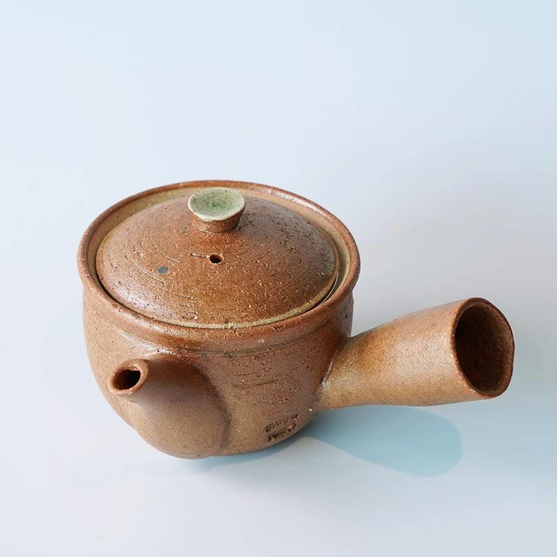 A reddish-brown Shigaraki-ware side-handled kyusu with its lid.